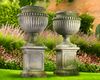 A PAIR OF LARGE AND IMPRESSIVE CARVED LIMESTONE GARDEN URNS ON PLINTHS IN IMPERIO TASTE, LATE 20TH CENTURY