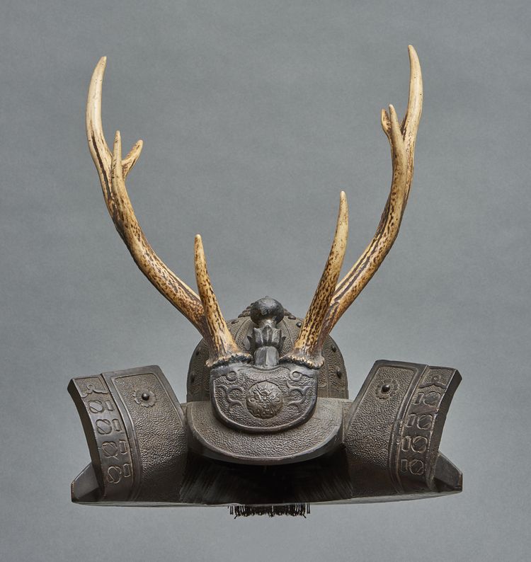 A sword stand (katanakake) in the shape of a black wooden hoshikabuto-helmet