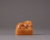 A Chinese yellow soapstone 'tiger' seal
