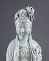 An exceptional large dehua glazed figure of Guanyin with child