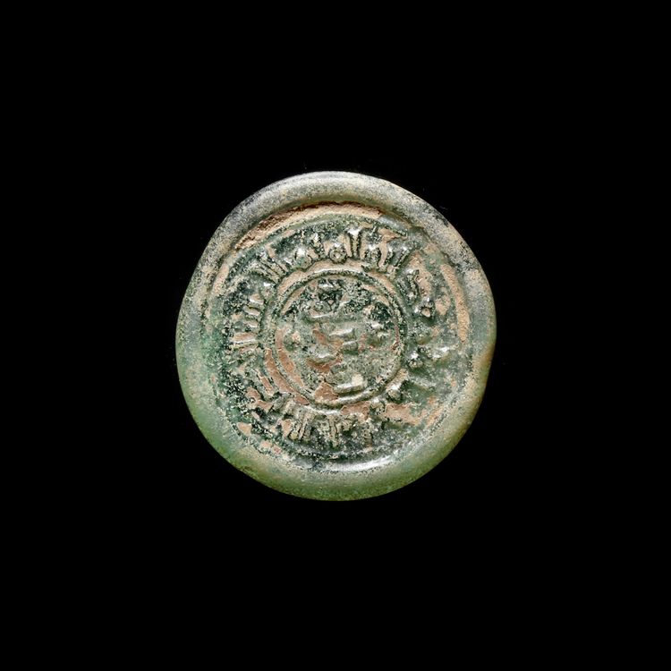 A FATIMID GLASS WEIGHT OF DIRHAM, EGYPT AL-MUSTANSIR BI-ALLAH (AH 427-487 / 1036-1094 AD)