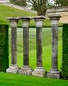 A SET OF FOUR CARVED LIMESTONE COLUMNS, 20TH CENTURY