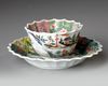 a CHINESE FAMILLE ROSE CHRYSANTHEMUM-FORM CUP AND SAUCER, EARLY QIANLONG PERIOD (1735-1795)