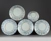 Four Chinese blue and white 'Kraak porcelain' chargers and a bowl