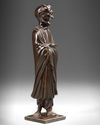 A CHINESE HARDWOOD CARVING OF LUOHAN HOLDING A SCROLL