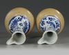 A pair of Chinese blue and white and cafe-au-lait glazed ewers