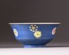 A Chinese blue-ground sgraffiato famille rose 'roundels' bowl