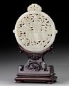 A CHINESE WHITE JADE ARCHAISTIC OPENWORK PLAQUE ON A WOODEN STAND, 19TH-20TH CENTURY