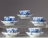 Five blue and white cups and saucers