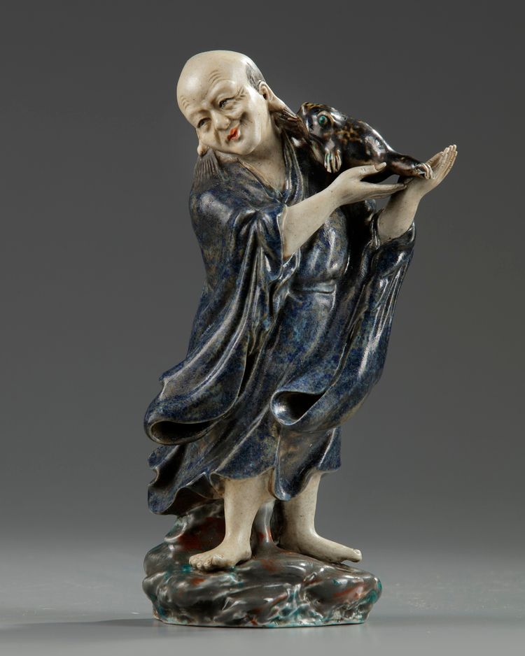 A Chinese enamelled porcelain figure of Liu Hai
