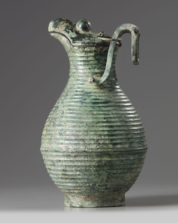 A large Chinese bronze hinged ewer and cover