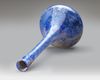 A TALL-NECKED BLUE GLASS BOTTLE PERSIA OR SYRIA, 11TH–12TH CENTURY