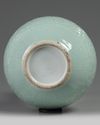 A CHINESE CARVED AND MOULDED CELADON-GLAZED BOTTLE VASE