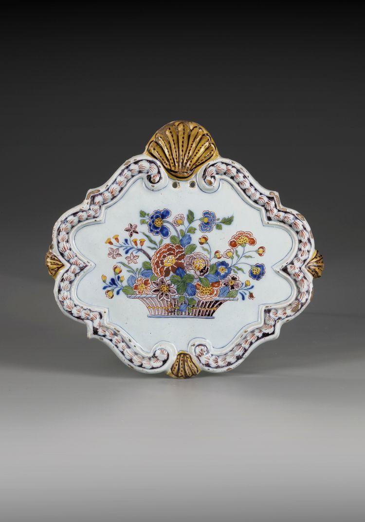A POLYCHROME PLAQUETTE WITH FLOWER BASKET, CA 1740 DELFT