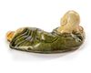 A CHINESE SANCAI CERAMIC BRUSH REST IN THE FORM OF A RECUMBENT BOY, SONG DYNASTY (960-1279)