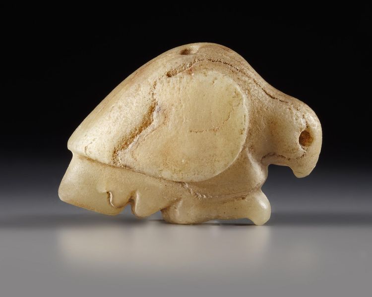 A WESTERN ASIATIC MARBLE SEAL AMULET IN THE FORM OF A BIRD OF PREY, LATE URUK PERIOD, CIRCA 3300-2900 B.C.