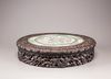 A famille rose panel inset into a hongmu circular table
