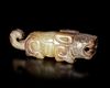A JADE OF A RECUMBENT TIGER WITH ITS TAIL CURLED UPWARD, CHINA, SHANG DYNASTY