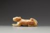 A celadon and russet jade carving of a hound