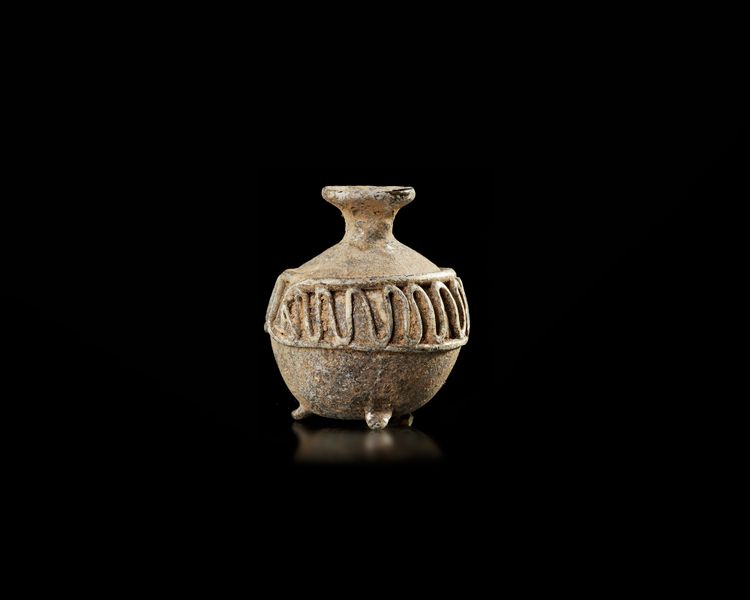 A SMALL TRIPOD FLASK, UMAYYAD, SYRIA, 7TH-8TH CENTURY