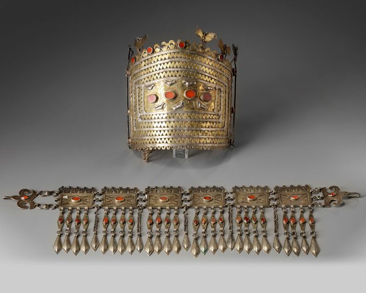 A silver inlaid and gilt tribe headdress and a necklace