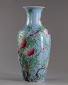 A Chinese blue-ground famille rose 'peaches' vase
