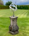 AN IRON ARMILLARY SUNDIAL ON A COMPOSTION STONE BASE IN LOUIS XIV STYLE,  LATE 19TH CENTURY