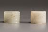 A Chinese white jade archers ring and a very pale celadon jade archers ring