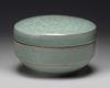 A KOREAN CELADON-GLAZED 'PEONIES' ROUND BOX AND COVER