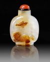 A CHINESE SHADOW AGATE 'BUDDHIST LION' SNUFF BOTTLE