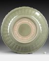 A LARGE LONGQUAN CELADON BARBED-RIM DISH