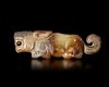A JADE OF A RECUMBENT TIGER WITH ITS TAIL CURLED UPWARD, CHINA, SHANG DYNASTY