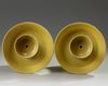 A pair of Chinese yellow-glazed candlestick holders