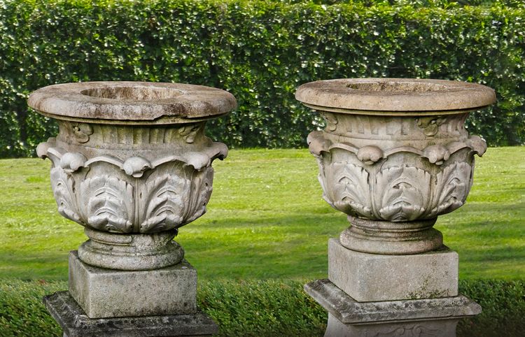 A PAIR OF FRENCH LIMESTONE GARDEN URNS ON PLINTHS, LATE 19TH CENTURY
