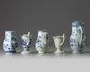 A GROUP OF FIVE CHINESE BLUE AND WHITE AND EN GRISAILLE POURING VESSELS