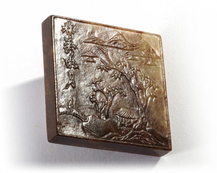 A Chinese celadon and russet jade square plaque