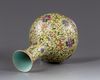 A Chinese yellow-ground famille rose bottle vase