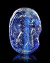 A BLUE GLASS SCARABOID SHOWING A MAN FIGHTING A LION, 6TH CENTURY BC