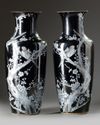A pair of Chinese black-ground enamelled 'magpie and prunus' vases