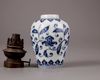 A Chinese blue and white jar with a copper oil lamp cover