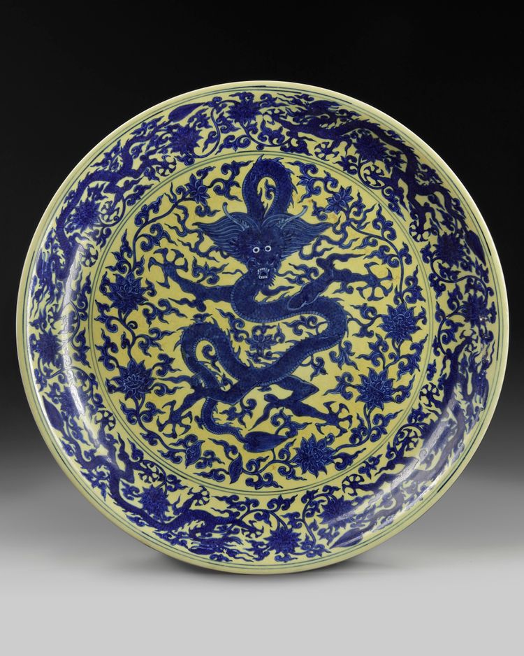 A massive Chinese yellow-glazed blue and white dragon charger