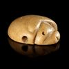 A NEAR EASTERN STAMP SEAL IN THE FORM OF A LION'S HEAD IN YELLOW CALCITE. 3rd. mil.B.C.