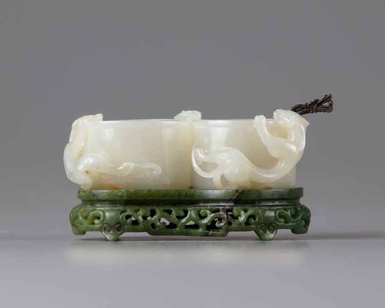 A white jade 'chilong' twin-cup and spinach green stand