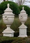 A PAIR OF LARGE AND IMPRESSIVE LIMESTONE CARVED GARDEN URNS ON PEDESTALS, LATE 20TH CENTURY
