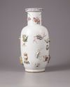 A Chinese famille rose moulded and appliqué 'precious objects' rouleau vase