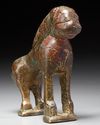 A BRONZE FATIMID MIRROR HANDLE IN THE FORM OF A LION, 11TH CENTURY
