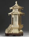 A carved ivory monk in a large ivory shrine. The Shrine is Chinese, the monk Japanese.