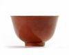 A coral-red glazed bowl