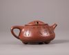 A Chinese yixing tripod teapot and cover