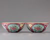 A pair of Chinese ruby-ground famille rose 'floral' bowls